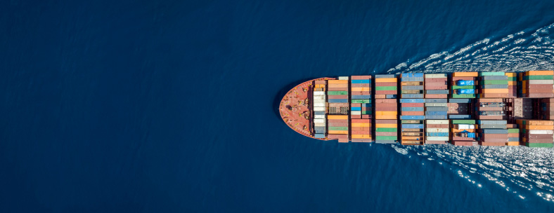 container ship navigating through blue ocean waters